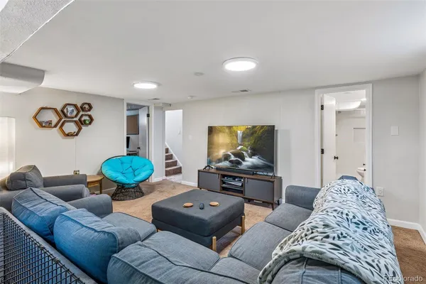 a living room with furniture and a flat screen tv