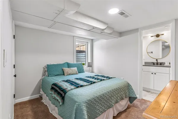 a bedroom with a bed and a dresser