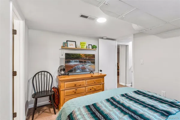 a bedroom with a bed and a dresser