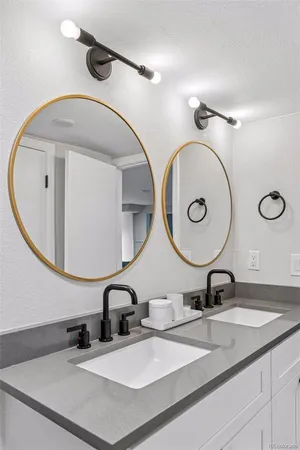 a bathroom with a double vanity sink and a mirror