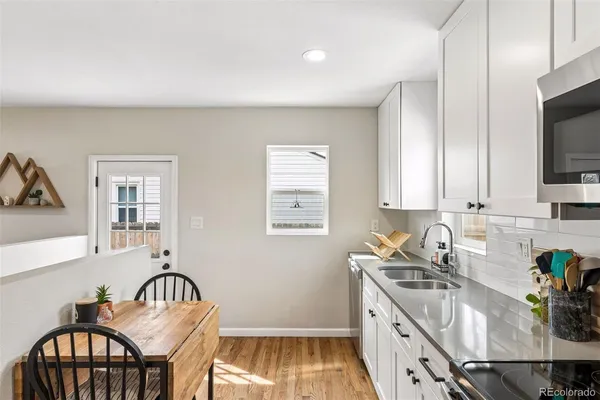 a kitchen with a sink a stove and cabinets