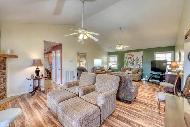 756 Doc Jones Road Blairsville, GA 30512 - Photo 20 of 46 a living room with furniture a chandelier and a flat screen tv