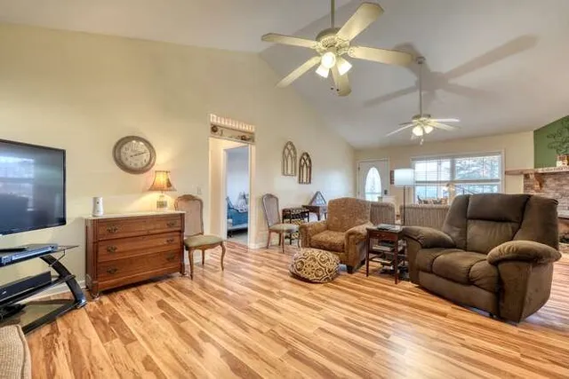 a kitchen with a stove a refrigerator and furniture