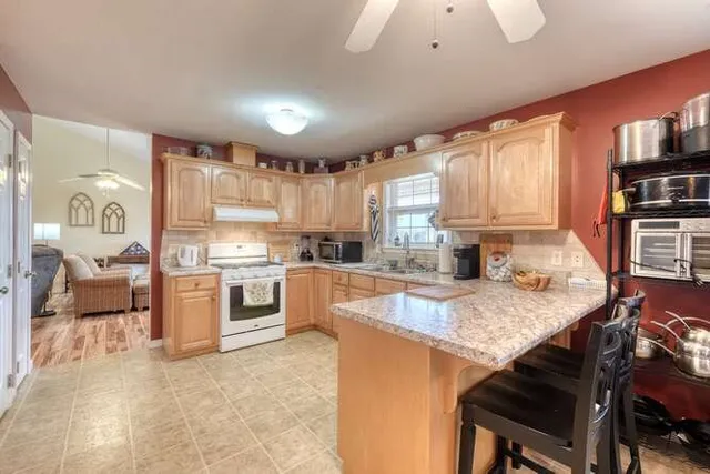 a view of a dining room with furniture and chandelier