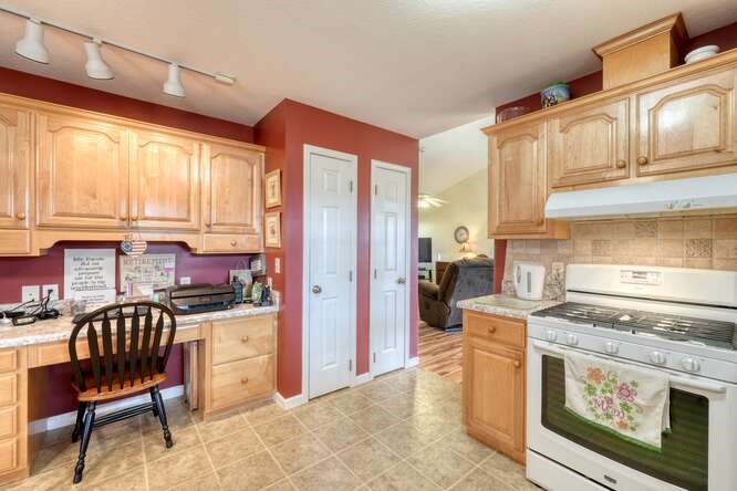 756 Doc Jones Road Blairsville, GA 30512 - Photo 26 of 46 a kitchen with stainless steel appliances granite countertop a stove a sink dishwasher and cabinets with wooden floor