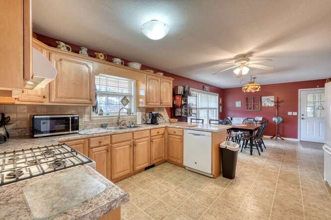 756 Doc Jones Road Blairsville, GA 30512 - Photo 3 of 46 a kitchen with cabinets and chairs