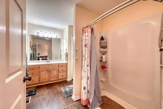 a bedroom with bed and a flat screen tv