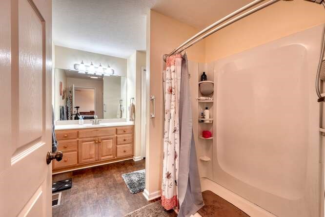 756 Doc Jones Road Blairsville, GA 30512 - Photo 35 of 46 a bathroom with a mirror a bathtub and shower