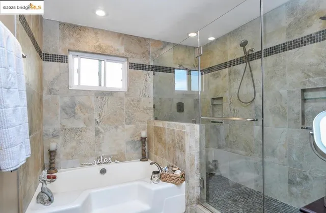 a bathroom with a shower and a tub sink