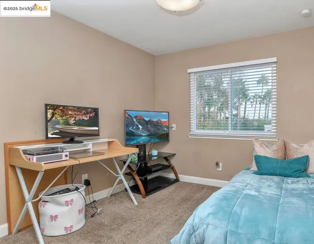 a bedroom with furniture and a window