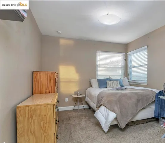 a bedroom with a bed and window