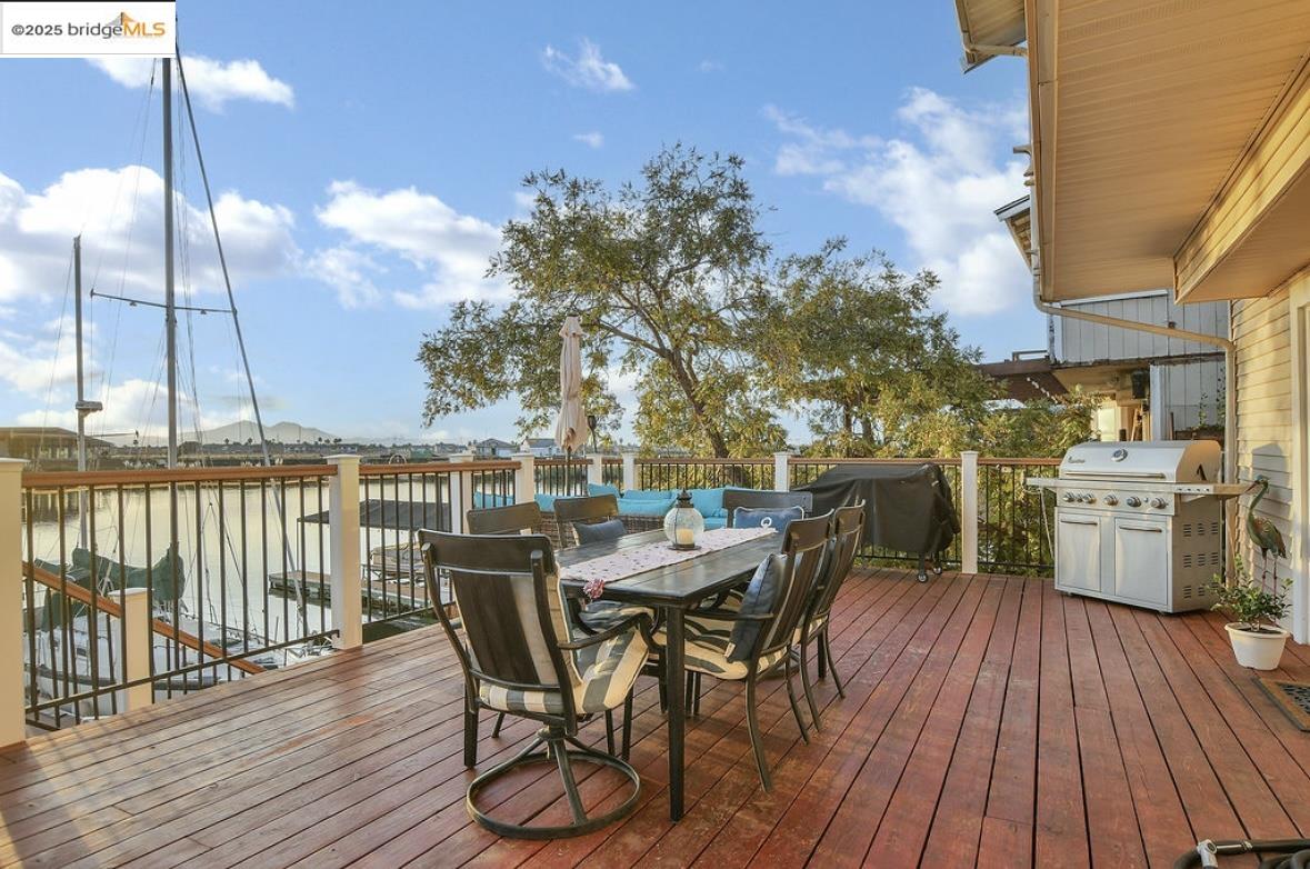 4930 Discovery Point Discovery Bay, CA 94505 - Photo 20 of 30 a view of a roof deck with table and chairs a barbeque with wooden floor