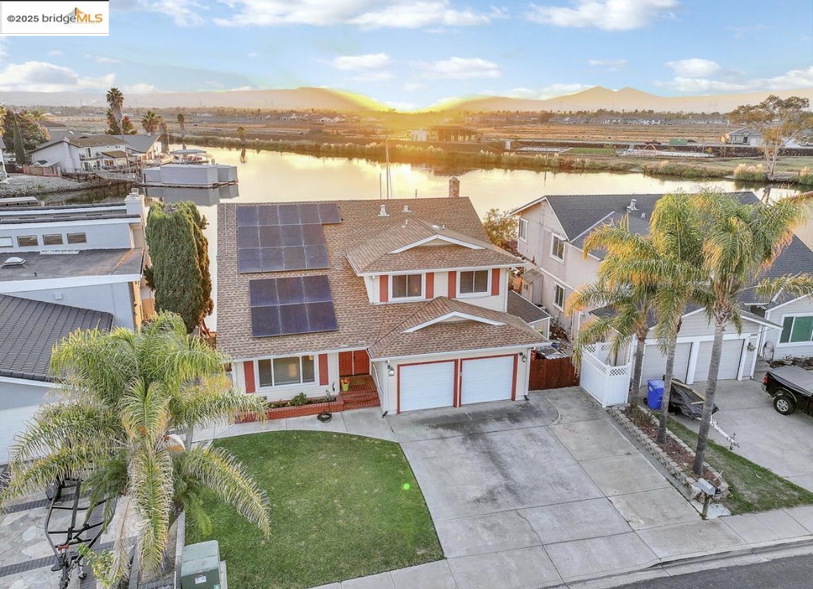 4930 Discovery Point Discovery Bay, CA 94505 - Photo 2 of 30 a front view of a house with a garden and lake view