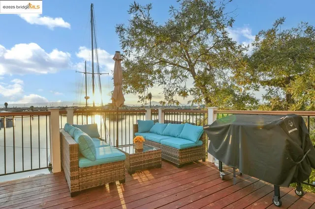 a view of a deck with couches and wooden floor