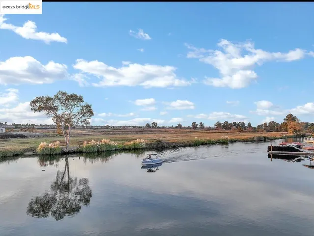 a view of a lake with houses in the back
