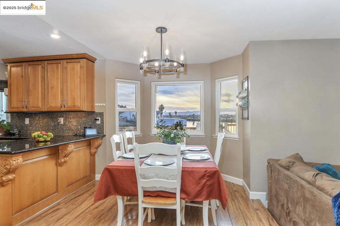 4930 Discovery Point Discovery Bay, CA 94505 - Photo 8 of 30 a dining room with furniture a chandelier and wooden floor