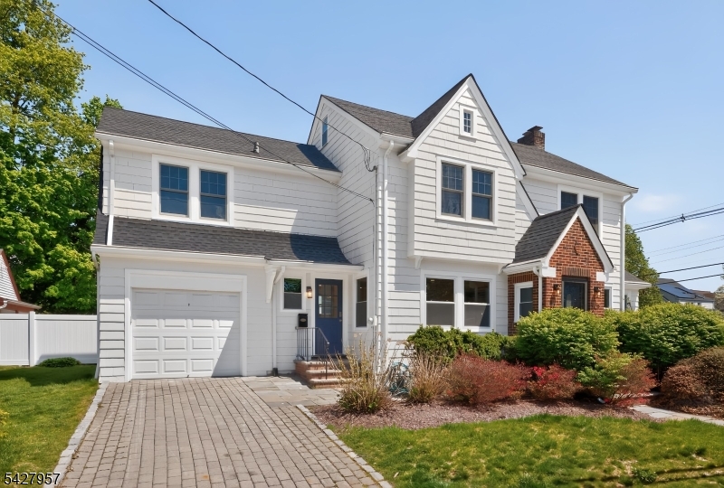 909 Ridgewood Road Millburn, NJ 07041 - Photo 2 of 33 a front view of a house with a yard