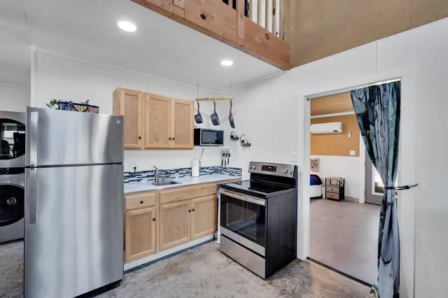 a view of a hallway with washer and dryer