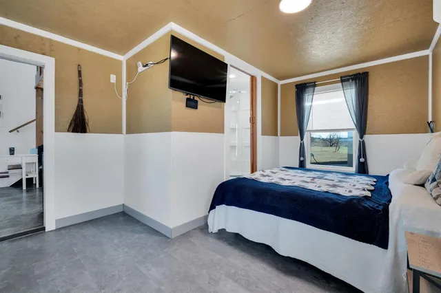 a bedroom with a bed and a mirror