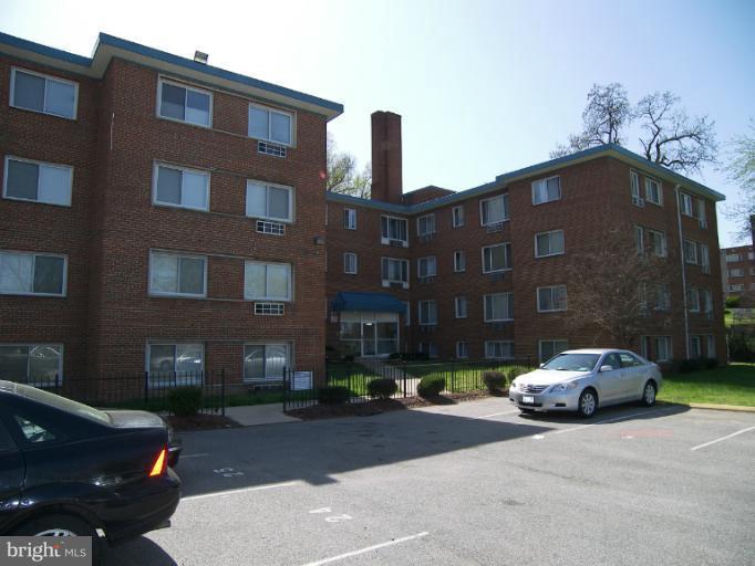 1907 Good Hope Road Southeast, Unit 311 Washington, DC 20020 - Photo 2 of 4 a car parked in front of brick building