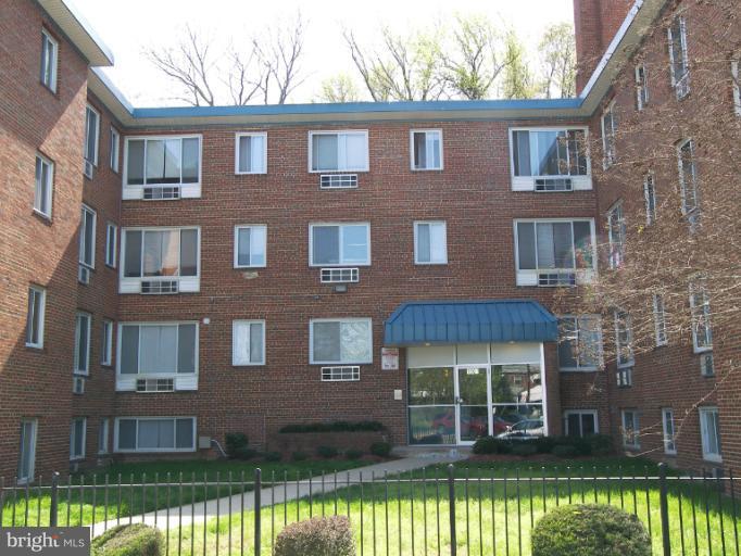1907 Good Hope Road Southeast, Unit 311 Washington, DC 20020 - Photo 4 of 4 a front view of a house with a yard large swimming pool and outdoor seating