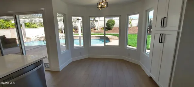 a view of hallway with furniture and a floor to ceiling window
