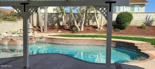a view of swimming pool from a living room