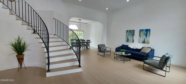 a living room with furniture and a potted plant