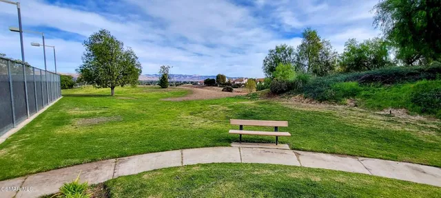 a view of a backyard with a garden and entertaining space