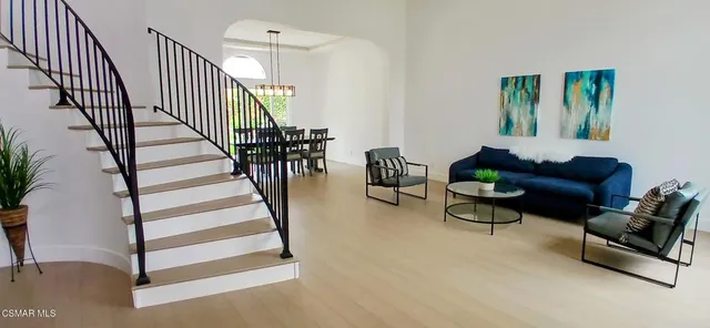 a living room with furniture and a book shelf