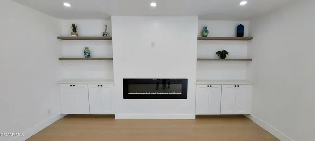 a view of kitchen with cabinets and wooden floor