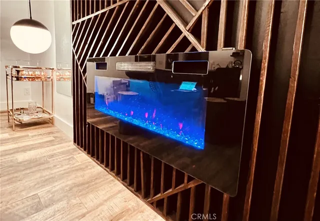 a living room with furniture a fireplace and a chandelier