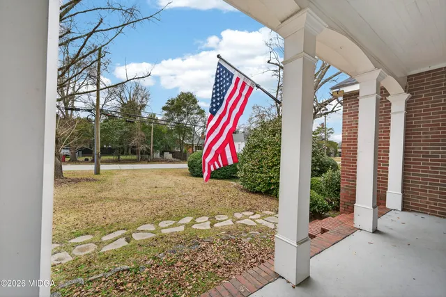 a view of a house with entryway wooden floor and a window