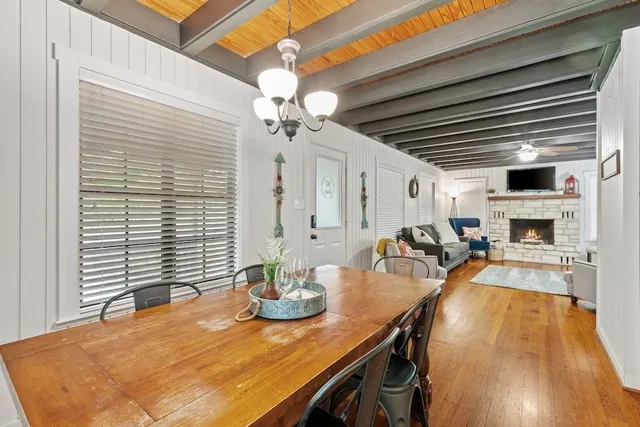 a view of a dining room with furniture and a chandelier