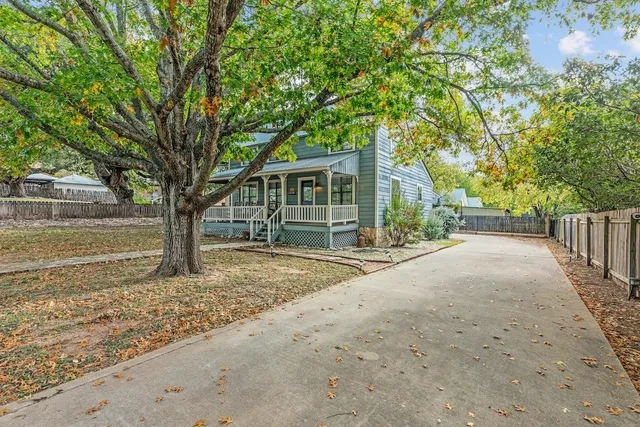 a view of a house with a tree in front