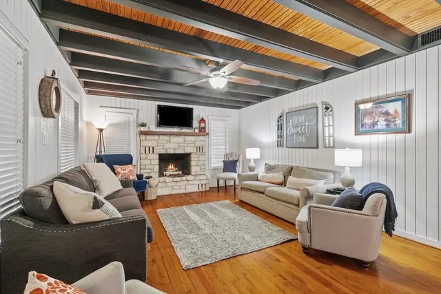 a living room with furniture and a fireplace