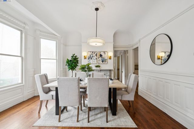 a view of a hallway with wooden floor and a mirror
