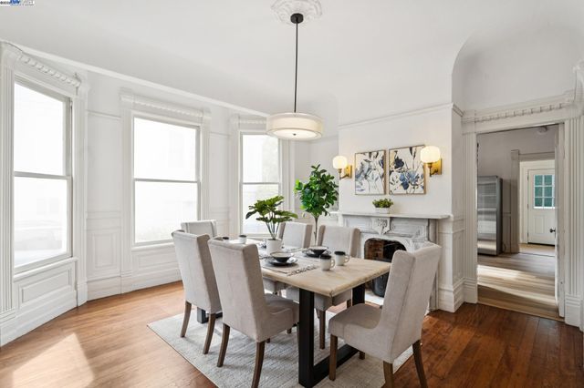 a view of a dining room with furniture window and wooden floor