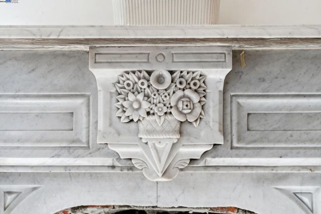 a kitchen with stainless steel appliances a stove a refrigerator and white cabinets with wooden floor