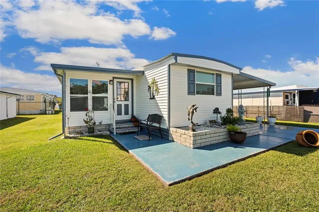 a view of a house with swimming pool and sitting area
