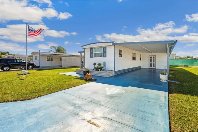a view of a house with swimming pool and a yard