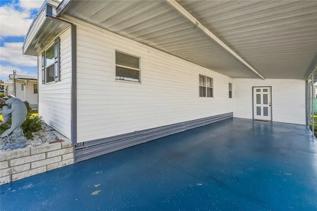 an aerial view of a house with swimming pool garden and patio