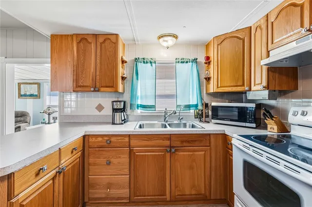 a kitchen with stainless steel appliances granite countertop a sink and cabinets