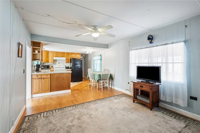 a view of a living room kitchen and a flat screen tv
