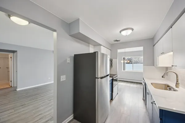 a kitchen with a refrigerator and a sink