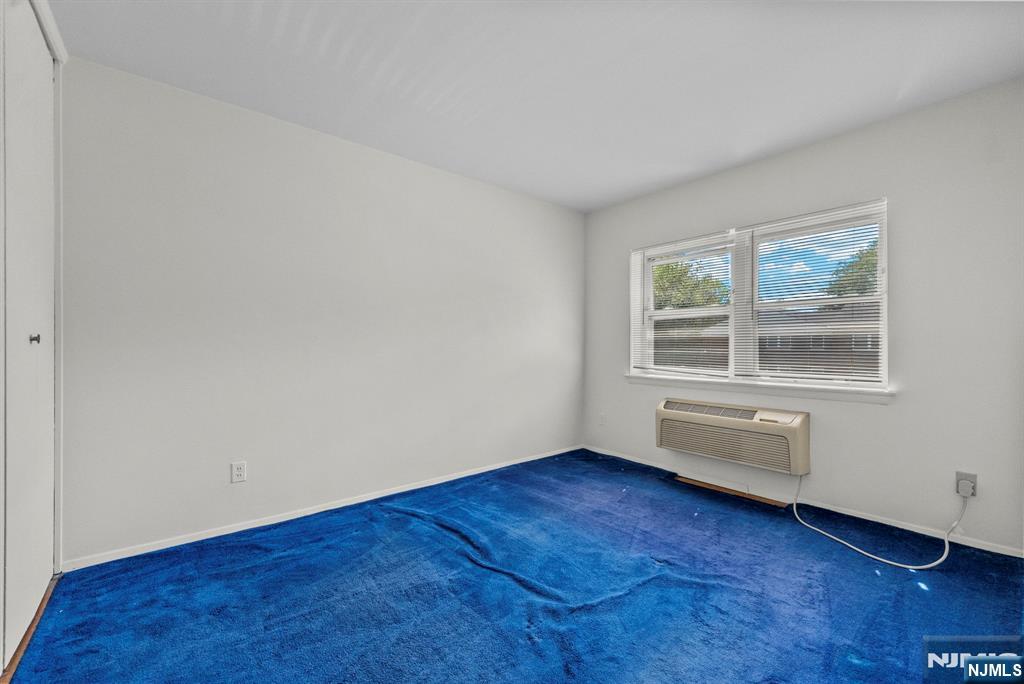 54 Westervelt Avenue, Unit B Tenafly, NJ 07670 - Photo 15 of 17 an empty room with wooden floor and windows