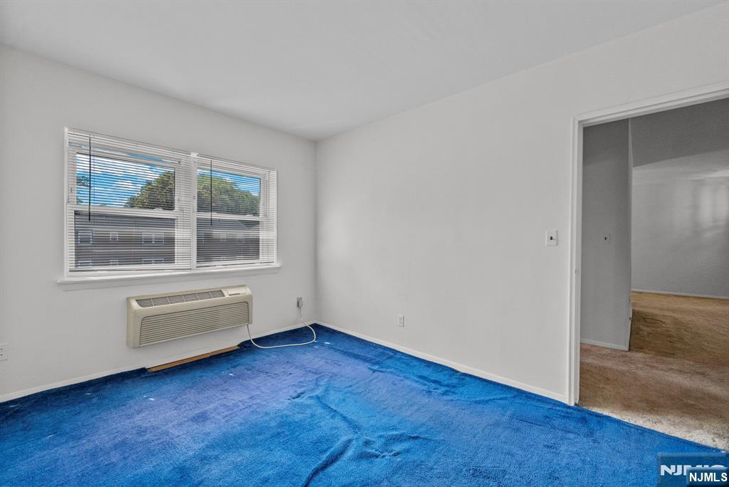 54 Westervelt Avenue, Unit B Tenafly, NJ 07670 - Photo 16 of 17 a view of an empty room with wooden floor and windows