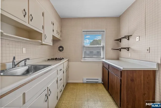 a kitchen with a sink stove and cabinets