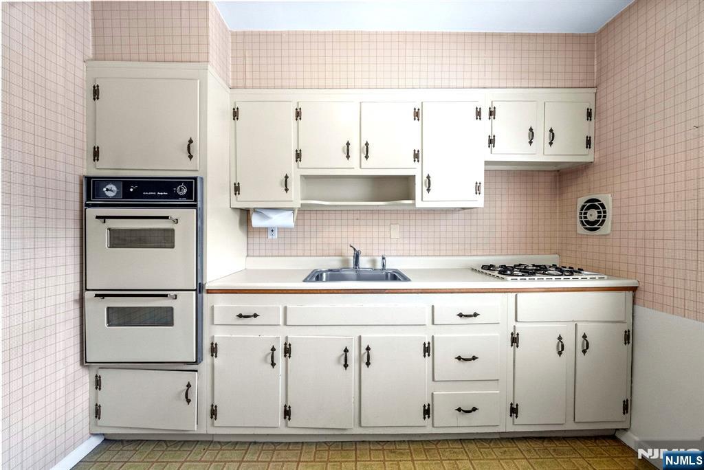 54 Westervelt Avenue, Unit B Tenafly, NJ 07670 - Photo 9 of 17 a kitchen with stainless steel appliances granite countertop a stove and a refrigerator