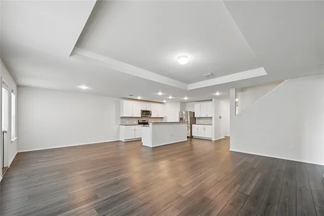 a view of a kitchen with kitchen island and wooden floor